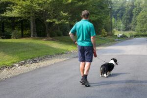 man going on a daily walk outside with his dog